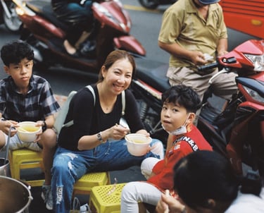 Vietnamese family having dinner on the pavement in Saigon