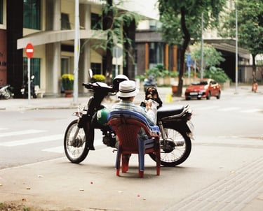 Motorbike driver resting on the street in Saigon