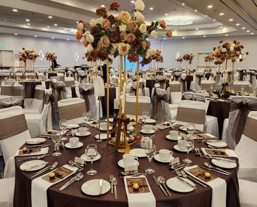  Luxury wedding reception table setup with tall gold floral centerpieces, brown and white table line
