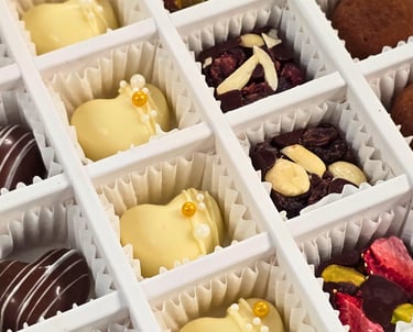 Gourmet Artisanal Assorted Chocolates including dark, milk, white chocolate, and truffles from Chocos Cookies Cakes