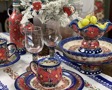 a table setting with a vase and a vase with fruit