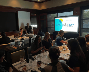 AV Tech with projector and screen for pharmaceutical dinner presentation. Laptops, virtual hybrid.