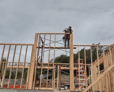 a man on a scaffolding on a construction site