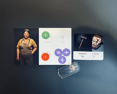 Photo of a player card with Intelligence and Agility skills, two item cards and player standee