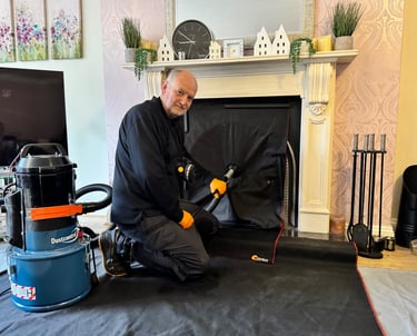 a man in a black jacket and gloves is sweeping a chimney