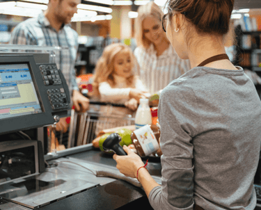 a woman is standing in front of a cash register