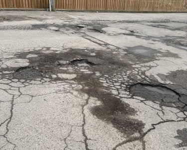 Multiple potholes in London Ontario plaza parking lot