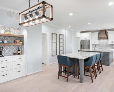 a kitchen with a marble counter top and a bar stool