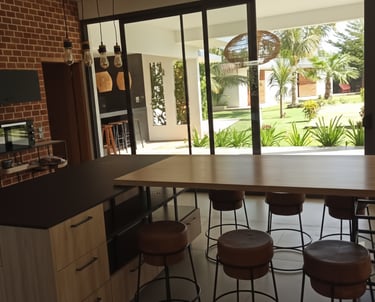 a kitchen with a bar stool and bar stools