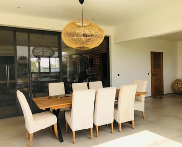 a dining room table with chairs and a chandelier