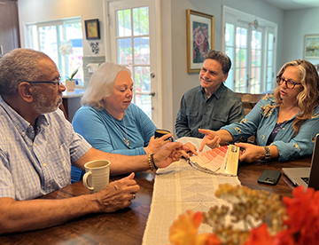 a group of people sitting around a table
