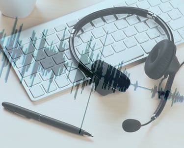 A keyboard, a pen, and headphones representing audio and video translations