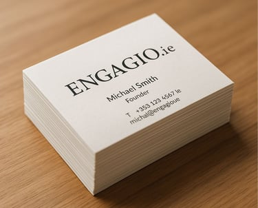 Stack of premium business cards with custom design and Engagio.ie branding placed on a modern wooden