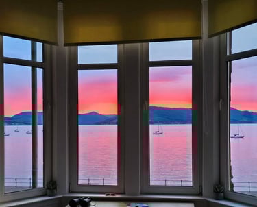 View from the window at at Gourock Seaview Holiday Let with a view of the ocean and sunset