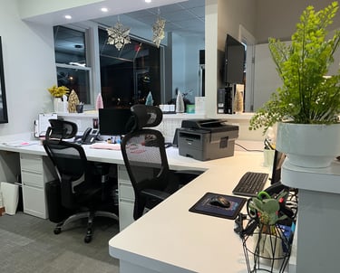 The desks to the receptionists inside a small office.