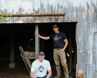 two men in opening of old barn