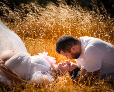 a man and woman in white wedding dress laying on the ground