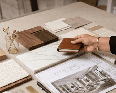 Bespoke interior design mood board with marble, wood samples, and architectural floor plans for tailored home styling.