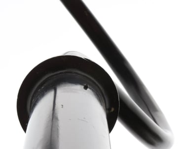 Black & white metal pole with curved part resembling a hook on a white sky..