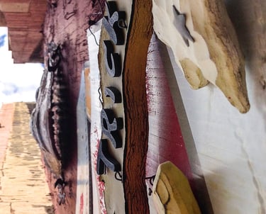 Upside down photo of a wall with several signs attached to it.