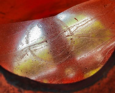 Bright red circular shiny object reflecting light.