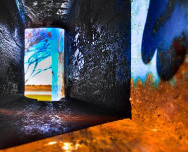 Looking through a deep rectangular hole into a blurred abstract landscape.