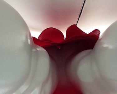 Closeup of a plastic female manekin in a red skirt.