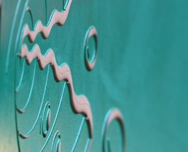 V-shaped and curved lines and circles on a green matte surface.