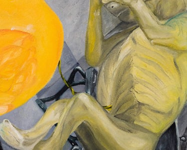 Painted yellow baby duck looking at the greenish fetus peeking through & sitting on the park bench.