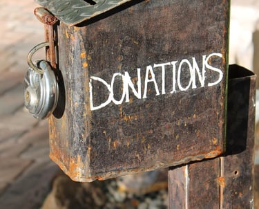 a rusty old metal box labeled donations