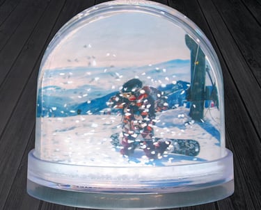 a snow globe with a snowboarder in the middle of it