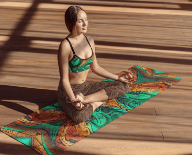 a woman in a bikini top sitting on a yoga mat