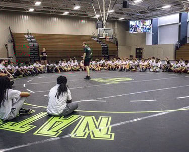 Wrestlers hearing from Coach Tre