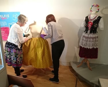 Mandy installing an eighteenth century dress in an exhibition