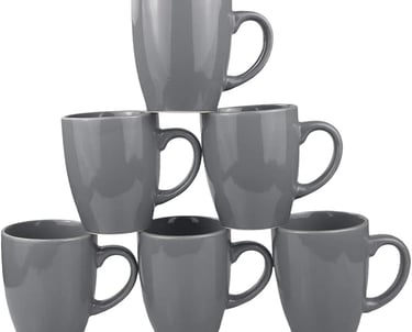 Set of six grey ceramic coffee mugs stacked in a pyramid on a white background.