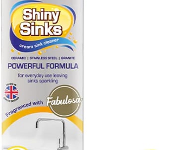 Shiny Sinks Lemon Sherbet cream sink cleaner bottle with a yellow scouring sponge.