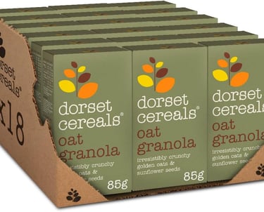 Bulk 18 pack of Dorset Cereals Oat Granola 85g boxes with golden oats and sunflower seeds.