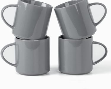 Set of four stackable grey ceramic coffee mugs with a glossy finish and speckled detail on a white background.