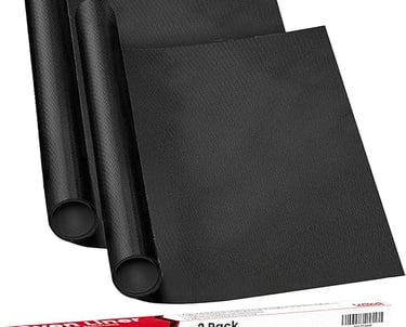 Two black reusable non-stick oven liners next to their premium thickness retail packaging box.