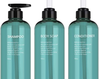 three bottles of body washer with a bottle of shampooe