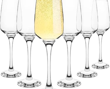 a row of wine glasses with champagne in front of a white background