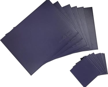 Set of navy blue faux leather placemats and matching coasters with embossed logos.