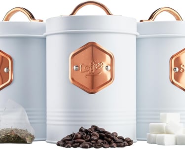 three canisters with coffee beans and sugar cubes