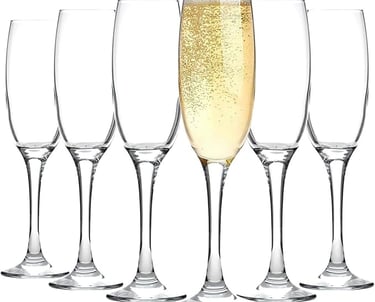 a row of wine glasses with champagne in front of a white background