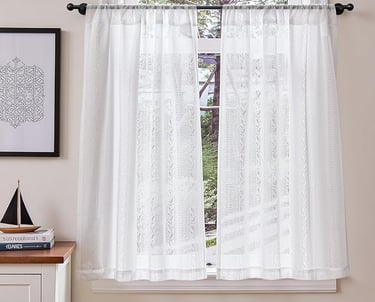 a window curtain with a sailboat on it