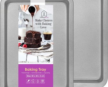 a baking tray with a cake and a cupcake