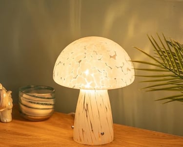 a mushroom shaped lamp with a mushroom on top of a wooden table