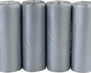 a group of four rolls of grey tissue paper rolls