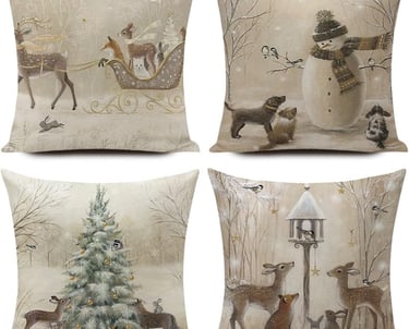 a set of four pillows with a snowman in the background