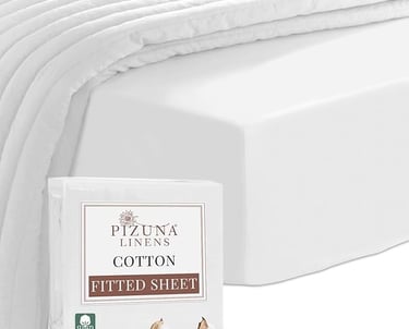 a bed with a white bedding and a pillow
